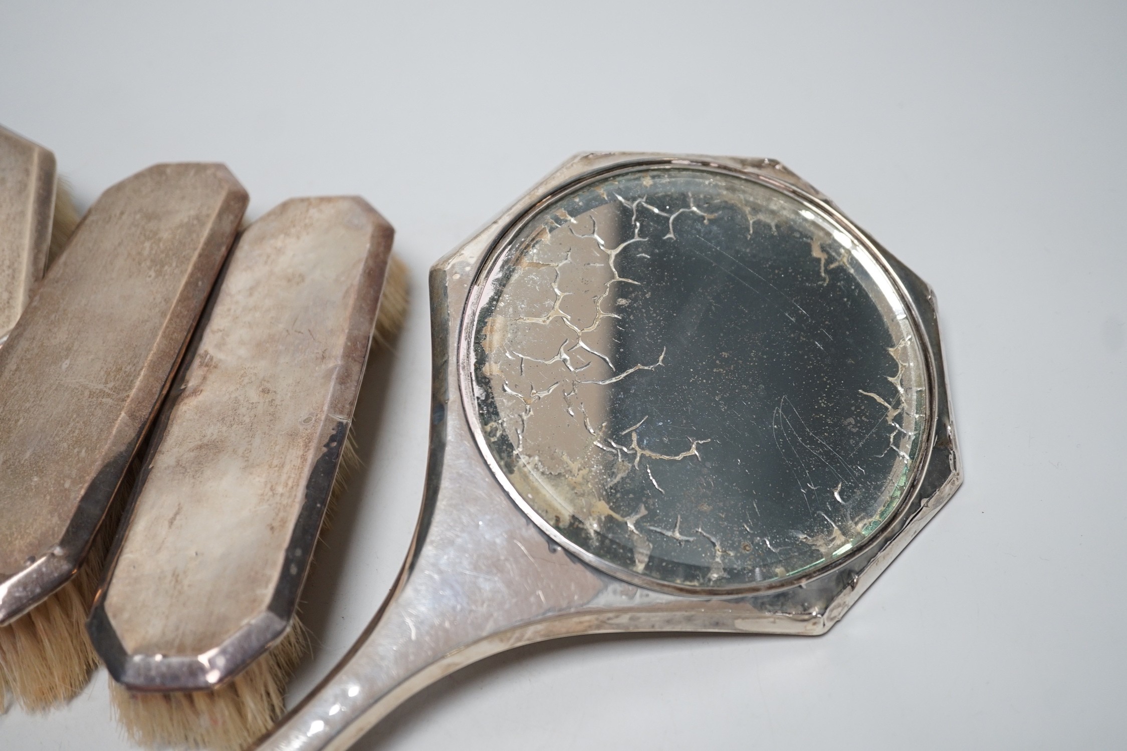 A 1920's silver mounted five piece mirror and brush set.